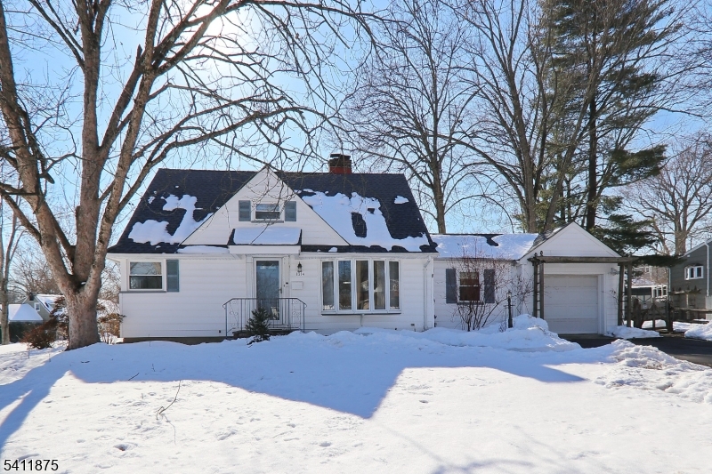 1314 Wood Valley Road Mountainside, NJ 07092 - Photo 2 of 40 a front view of a house with a yard covered with snow
