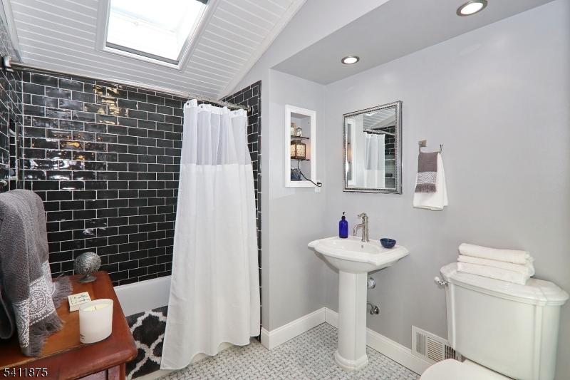 1314 Wood Valley Road Mountainside, NJ 07092 - Photo 24 of 40 a bathroom with a sink mirror and toilet