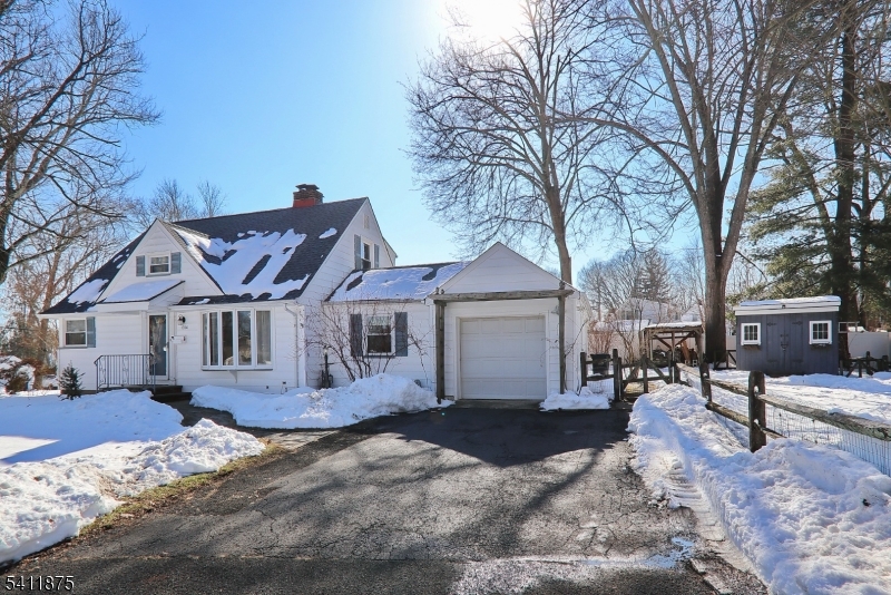 1314 Wood Valley Road Mountainside, NJ 07092 - Photo 3 of 40 a view of a house with a yard covered in snow