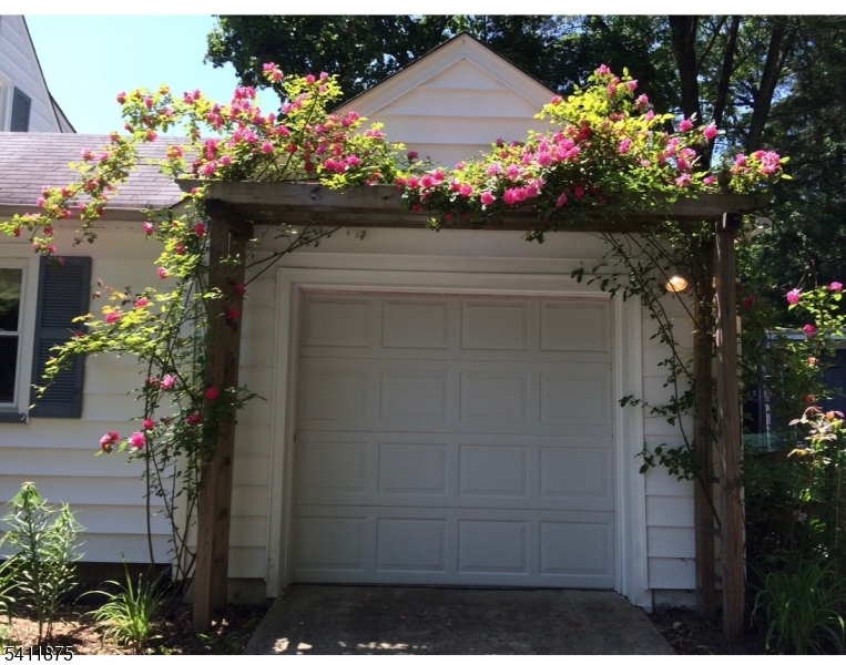 1314 Wood Valley Road Mountainside, NJ 07092 - Photo 39 of 40 a front view of a house with a lot of flowers