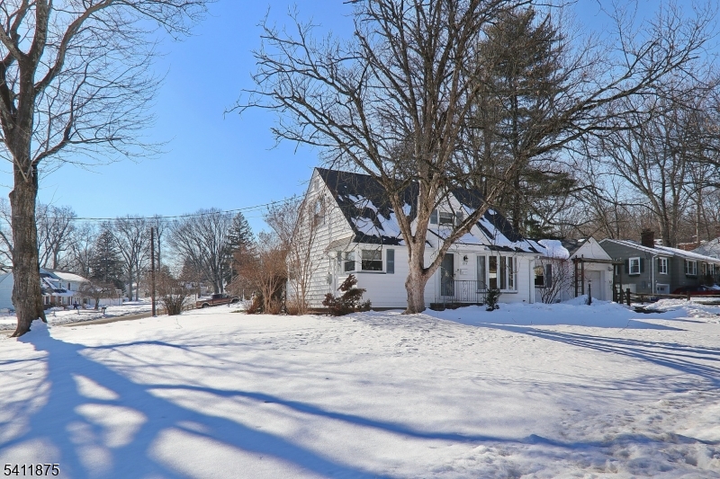 1314 Wood Valley Road Mountainside, NJ 07092 - Photo 4 of 40 a front view of a house with a yard covered in snow