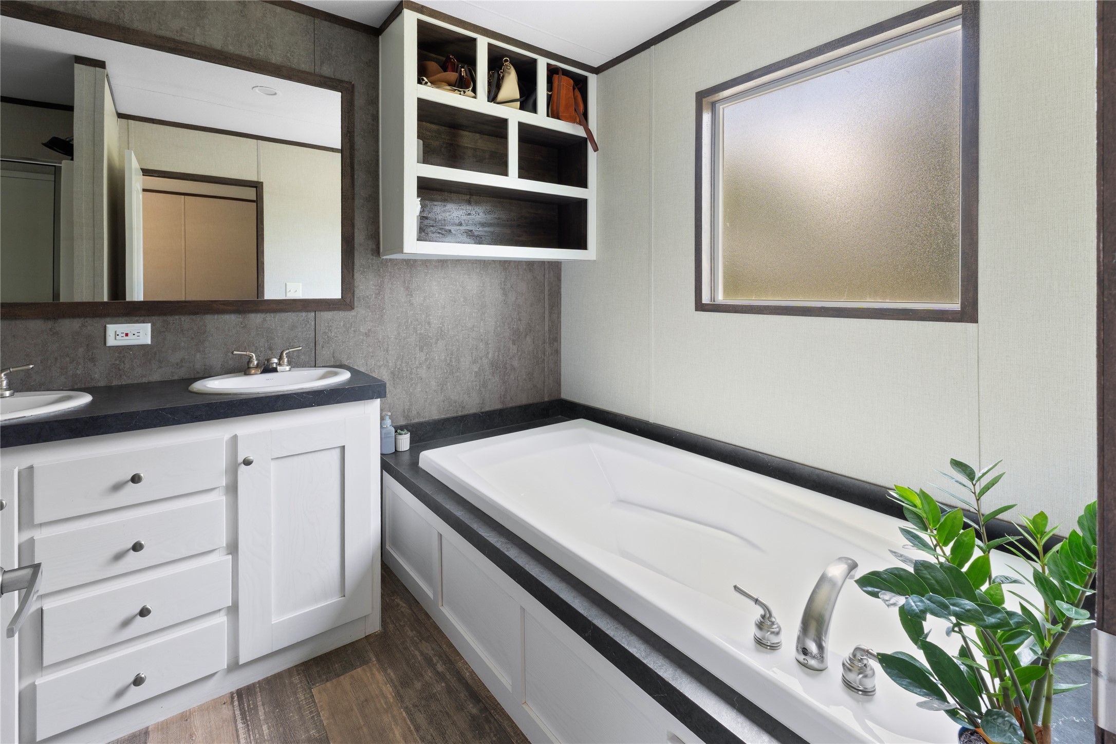 109 Hibiscus Cove Elgin, TX 78621 - Photo 9 of 15 Double vanity and a deep soaking tub create a restful bathroom retreat.