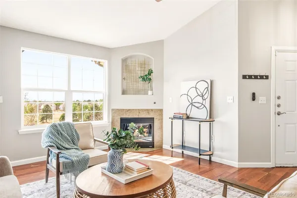 a living room with furniture fireplace and a window