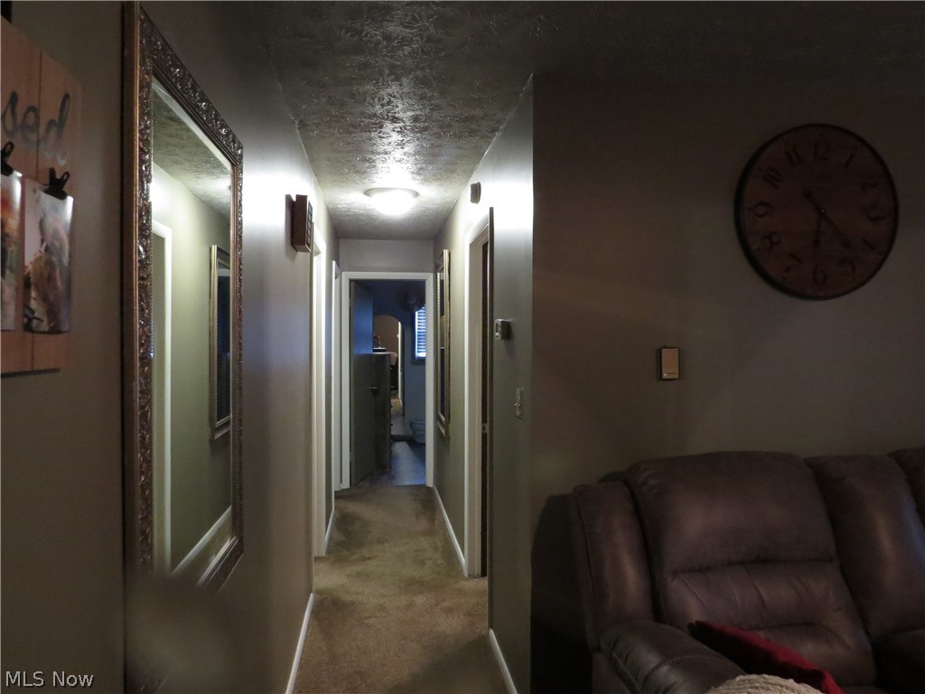 9811 Church Road Huron, OH 44839 - Photo 13 of 28 Hallway with a textured ceiling and carpet flooring