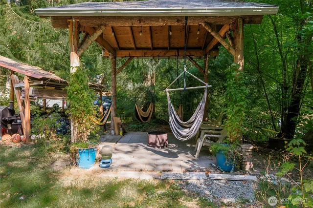 a view of a backyard with plants and a fountain