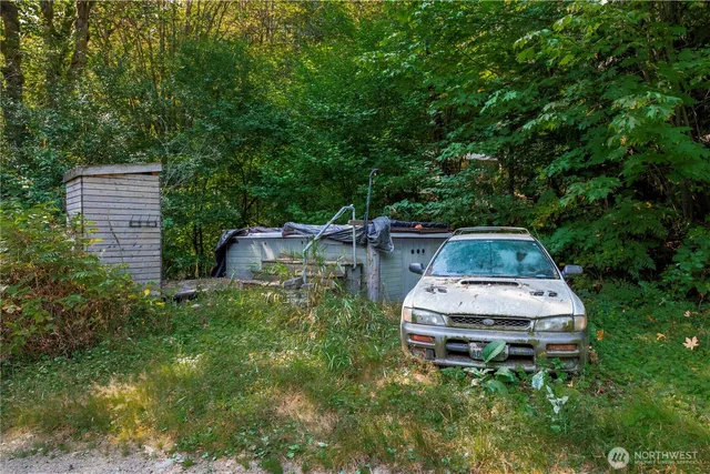 a backyard of a house with table and chairs