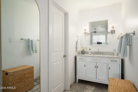 a bathroom with a granite countertop sink and a mirror
