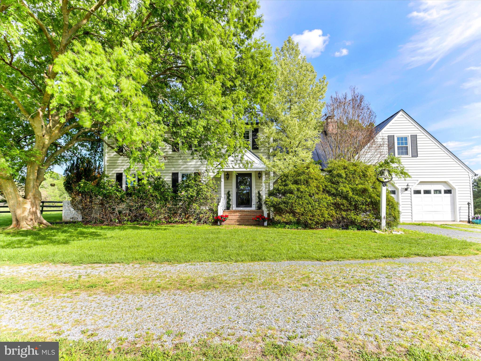 19255 Telegraph Springs Road Purcellville, VA 20132 - Photo 3 of 107 a front view of a house with a yard and garage
