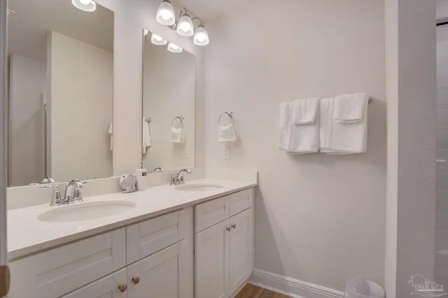 a bathroom with a sink vanity and mirror
