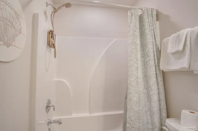 a bathroom with a shower curtain and a sink