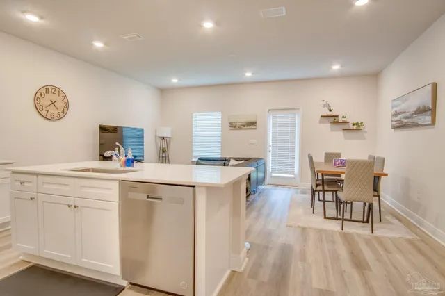 a kitchen with a sink cabinets and wooden floor