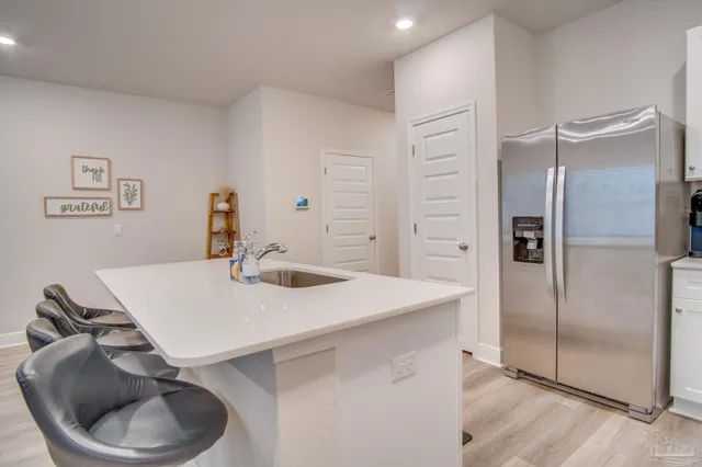 a kitchen with stainless steel appliances cabinets and wooden floor