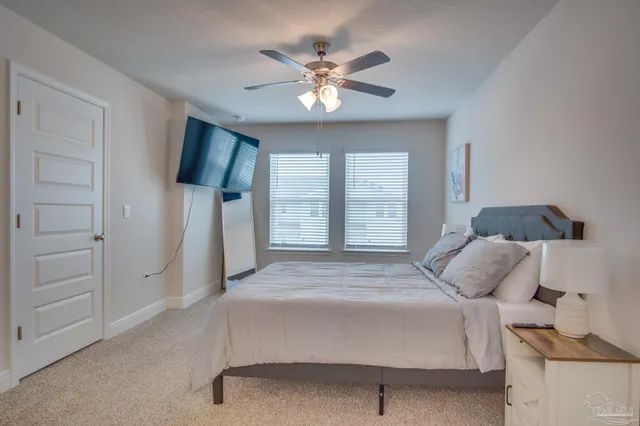 a bedroom with a bed and a chandelier