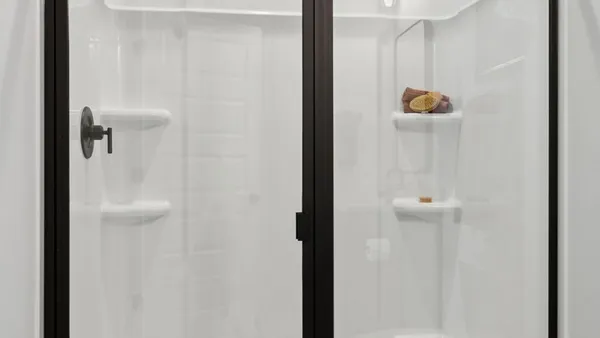 a kitchen with stainless steel appliances a dining table chairs sink and cabinets