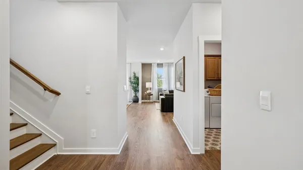 a open dining room with stainless steel appliances granite countertop a dining table chairs and a living room