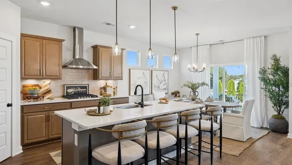 a kitchen with stainless steel appliances kitchen island granite countertop a stove a sink and a refrigerator
