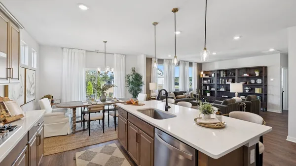 a living room with furniture and a view of kitchen