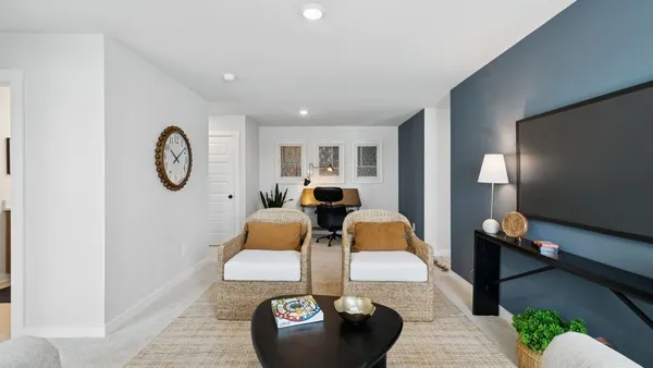 a dining room with furniture and a large window