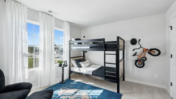 a view of a chair and table in backyard of the house