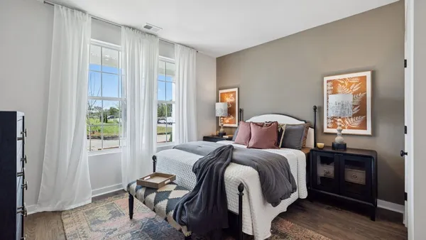 a kitchen with stainless steel appliances granite countertop a stove a refrigerator a kitchen island a dining table and chairs with wooden floor