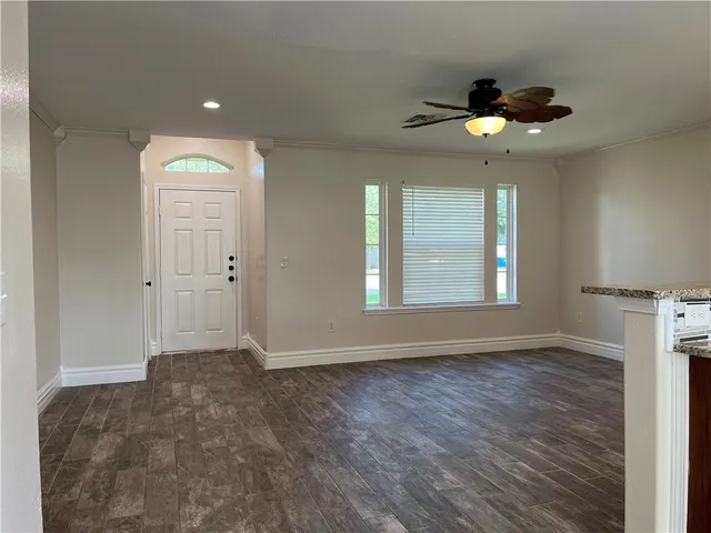 wooden floor in an empty room with a window