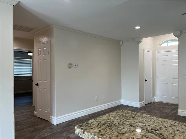 a view of a hallway with wooden floor and closet