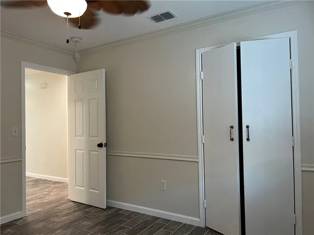 a view of a room with wooden floor