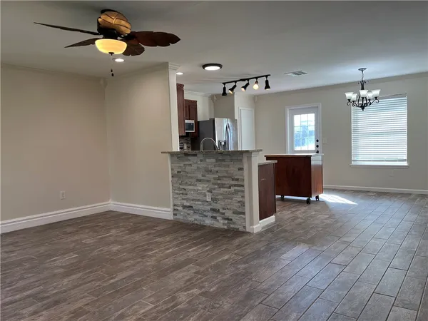 a view of a livingroom with hardwood floor and a ceiling fan