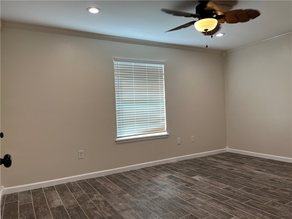 1219 Sacramento Street Portland, TX 78374 - Photo 28 of 40 an empty room with wooden floor and windows