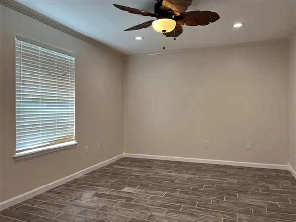 wooden floor in an empty room with a window