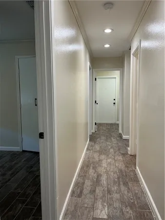 a view of hallway with wooden floor