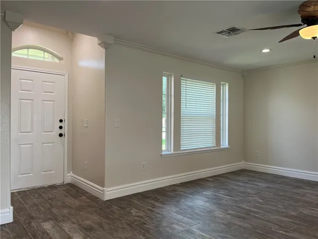wooden floor in an empty room with a window
