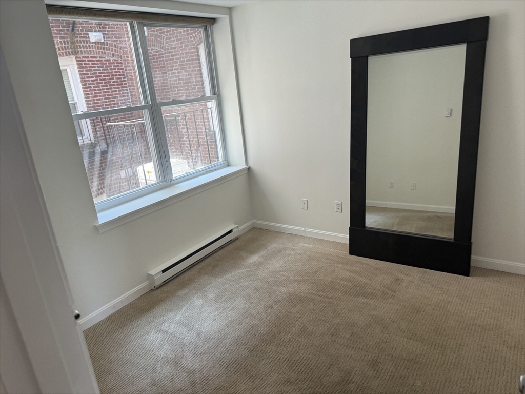 160 Cottage Street, Unit 2 Boston, MA 02128 - Photo 5 of 11 an empty room with windows