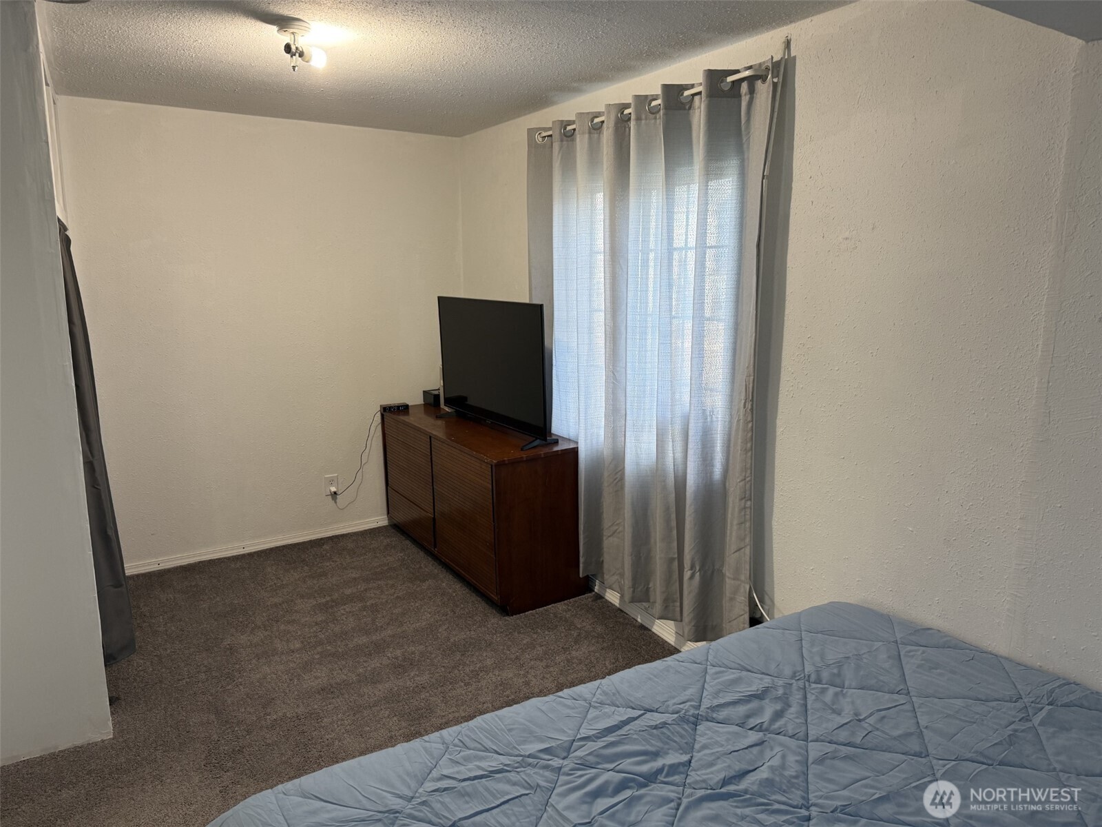 319 East Section Street Mount Vernon, WA 98273 - Photo 6 of 22 a bedroom with a bed and a flat screen tv