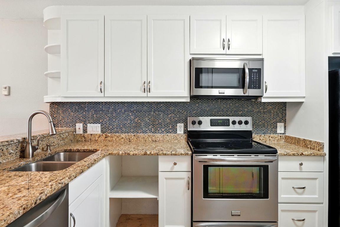 2918 Ranch Road 620 North, Unit C115 Austin, TX 78734 - Photo 11 of 39 Kitchen featuring stainless steel appliances, open shelves, white cabinets, light stone countertops, and tasteful backsplash