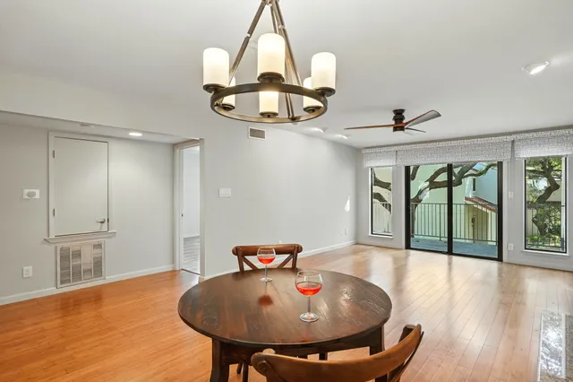 a view of a dining room with furniture wooden floor and chandelier