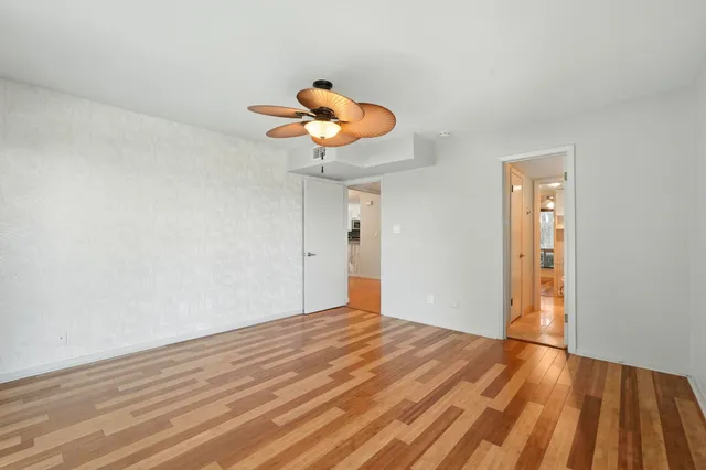 a view of an empty room and wooden floor