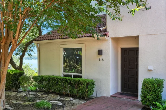 front view of a house with a tree