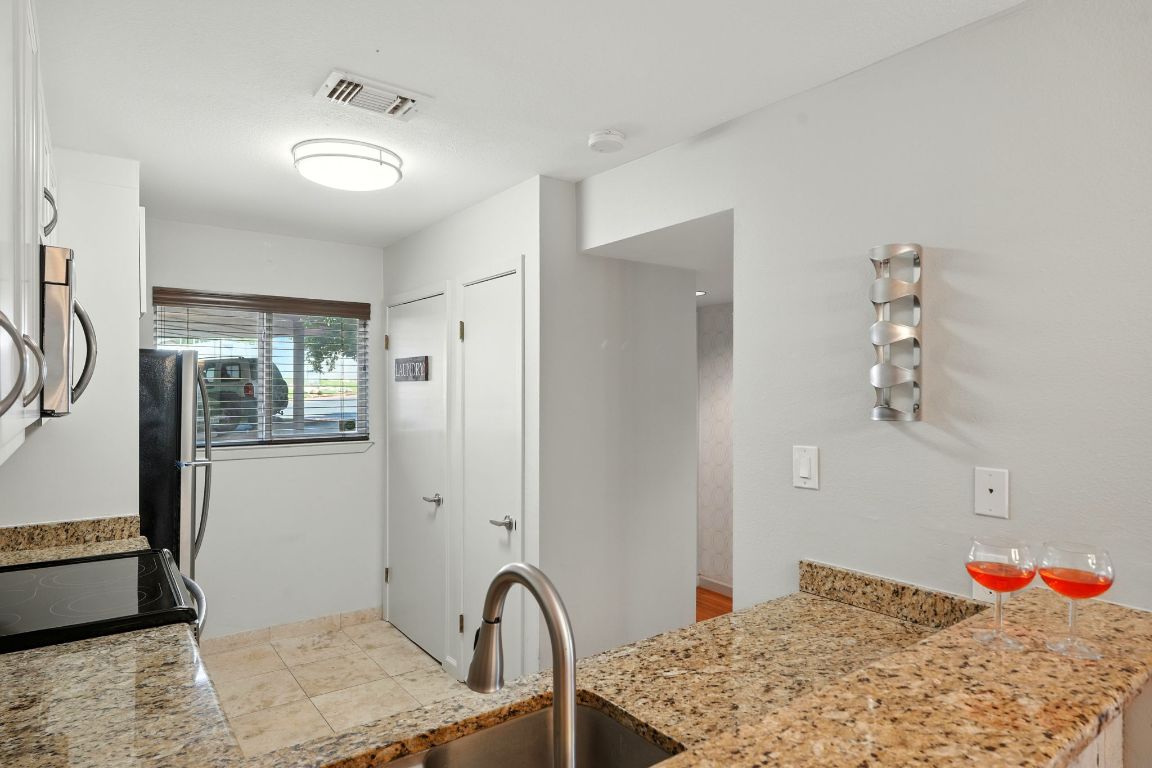 2918 Ranch Road 620 North, Unit C115 Austin, TX 78734 - Photo 7 of 39 Kitchen featuring white cabinetry and freestanding refrigerator