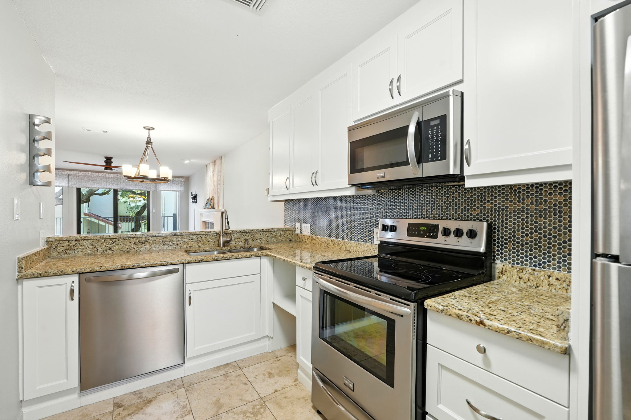 2918 Ranch Road 620 North, Unit C115 Austin, TX 78734 - Photo 8 of 39 Kitchen with stainless steel appliances, white cabinets, light stone countertops, and light tile patterned floors