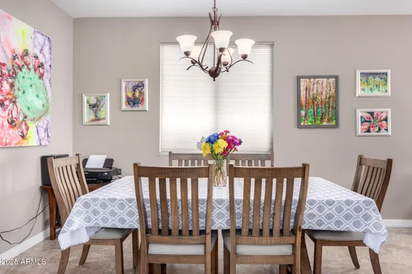 a view of a dining room with furniture and a chandelier