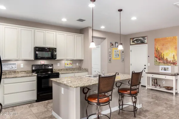 a kitchen with a sink stainless steel appliances and cabinets