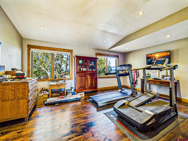 a living room with lots of furniture and a wooden floor