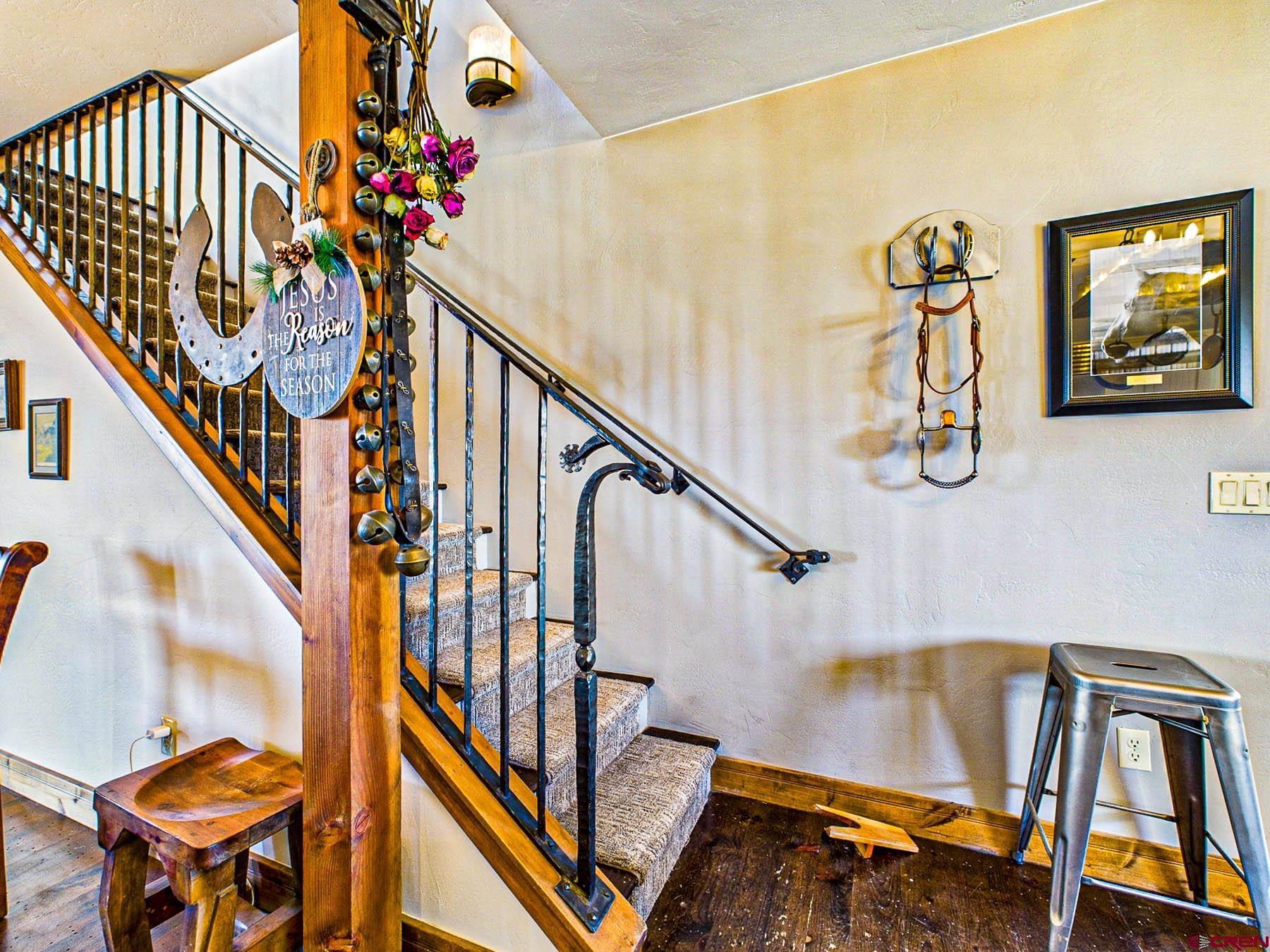 2741 7750th Road Crawford, CO 81415 - Photo 20 of 45 a view of staircase with furniture and lots of frames on wall
