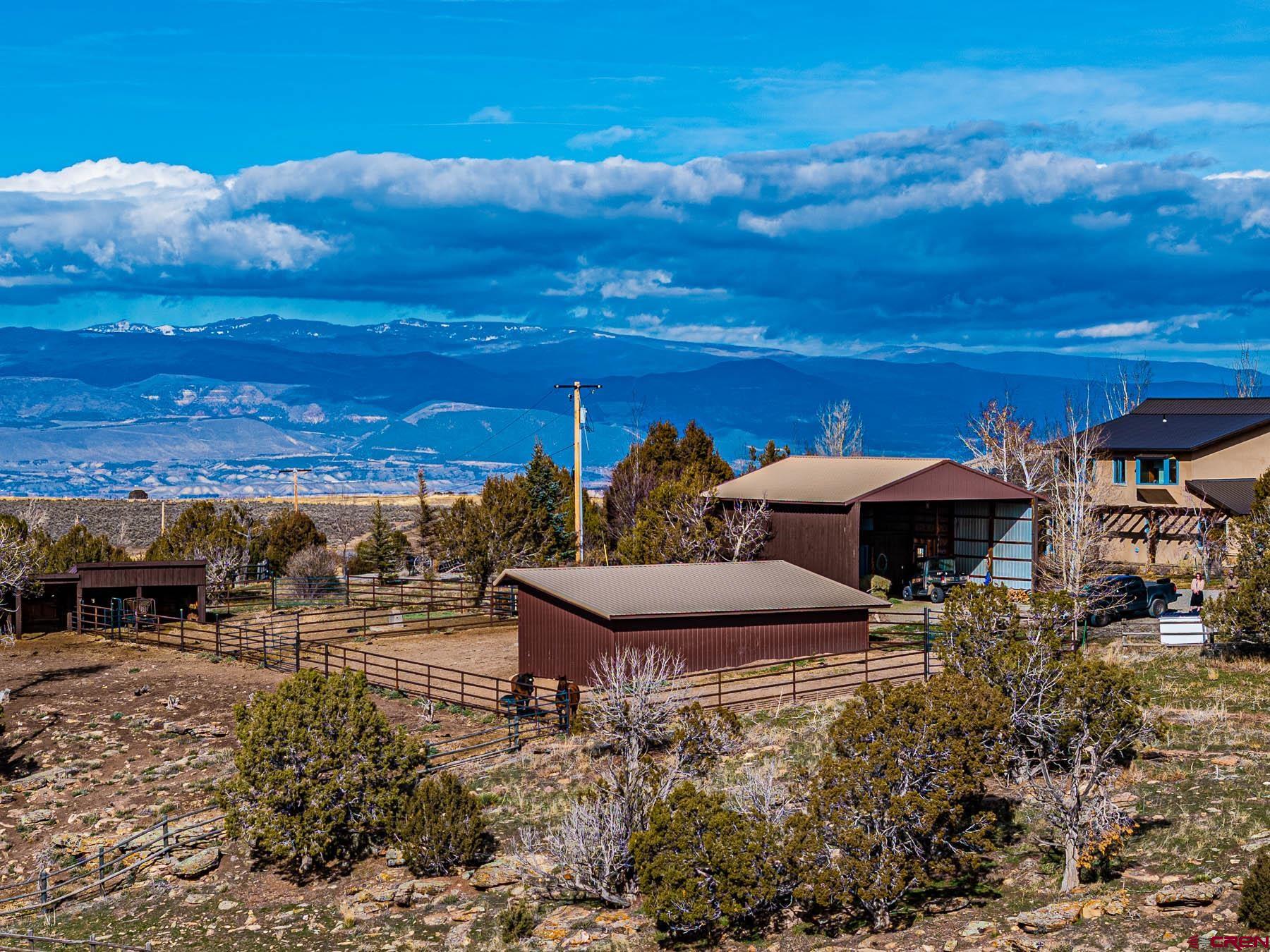2741 7750th Road Crawford, CO 81415 - Photo 34 of 45 a roof deck with table and chairs under an umbrella