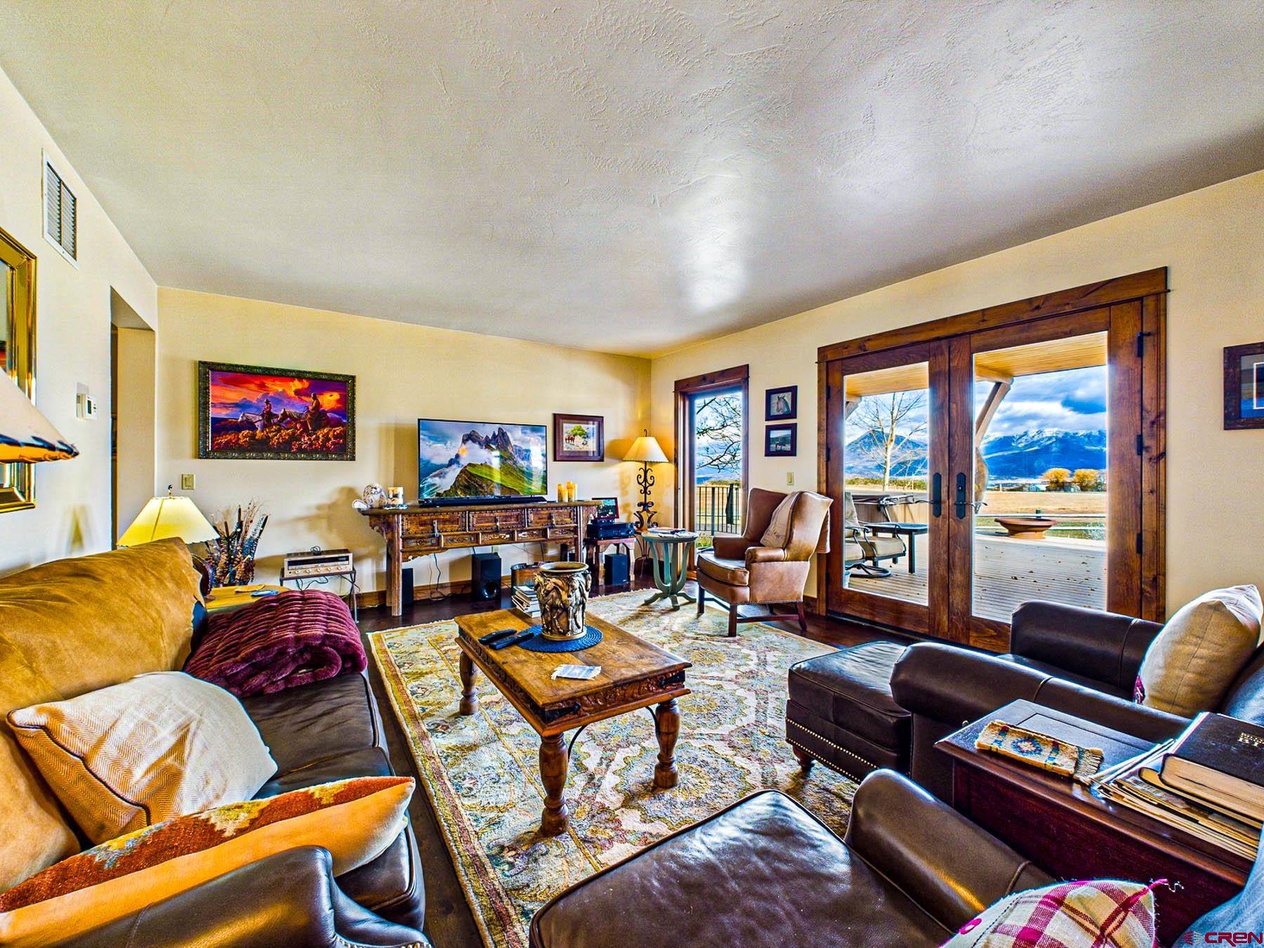 2741 7750th Road Crawford, CO 81415 - Photo 10 of 45 a living room with furniture a bookshelf and a window