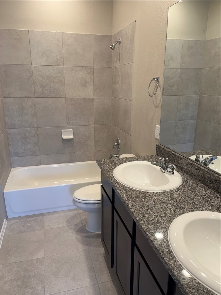 1139 Garland Road Georgetown, TX 78626 - Photo 11 of 14 a bathroom with a granite countertop sink a toilet and bathtub