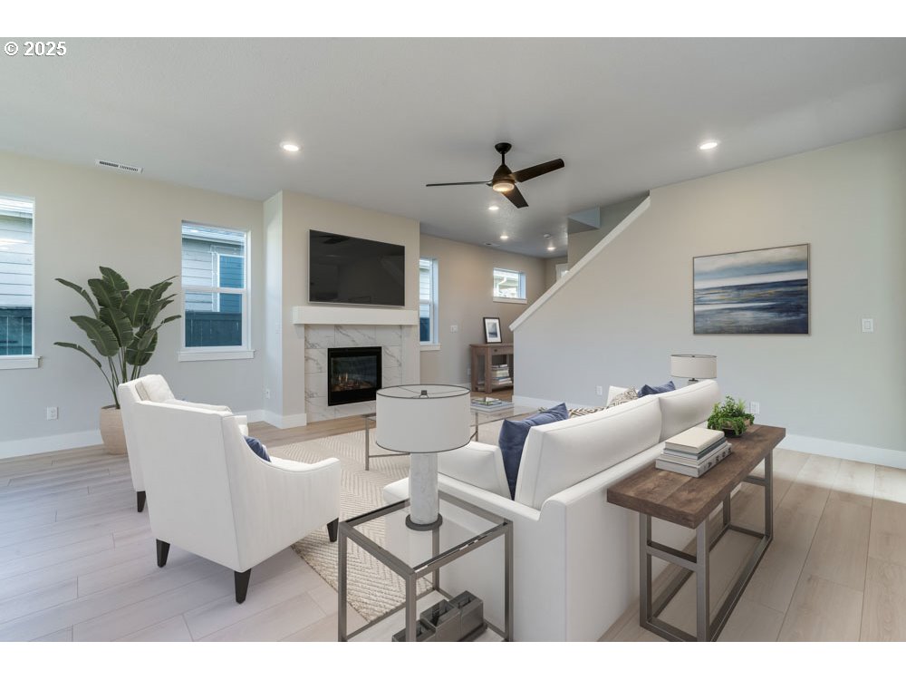 1330 East Canto Street Newberg, OR 97132 - Photo 2 of 9 a living room with furniture a flat screen tv and a fireplace