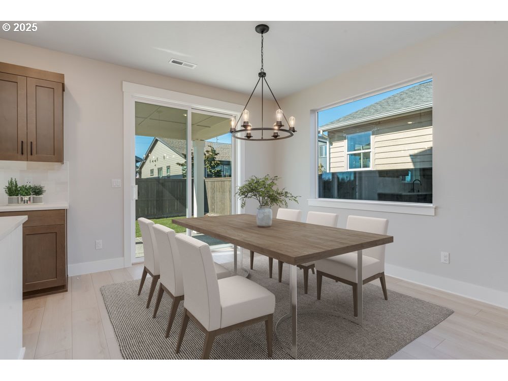 1330 East Canto Street Newberg, OR 97132 - Photo 4 of 9 a view of a dining room with furniture window and wooden floor