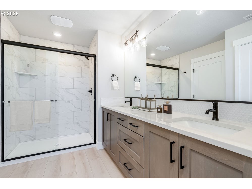 1330 East Canto Street Newberg, OR 97132 - Photo 6 of 9 a bathroom with a double vanity sink mirror and shower